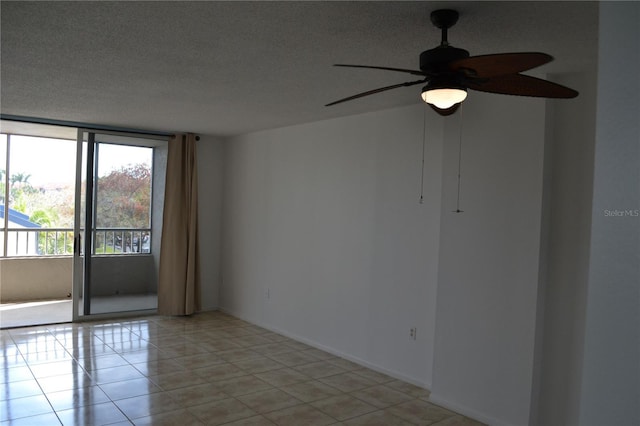 empty room featuring ceiling fan, a textured ceiling, and light tile patterned floors