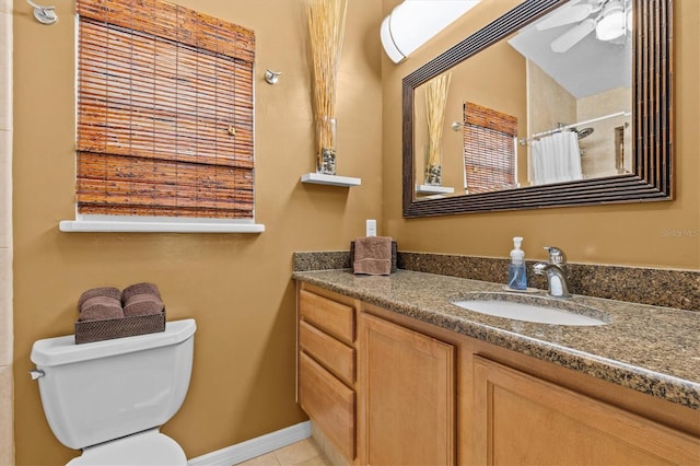 bathroom featuring toilet, a ceiling fan, vanity, a shower with curtain, and tile patterned flooring