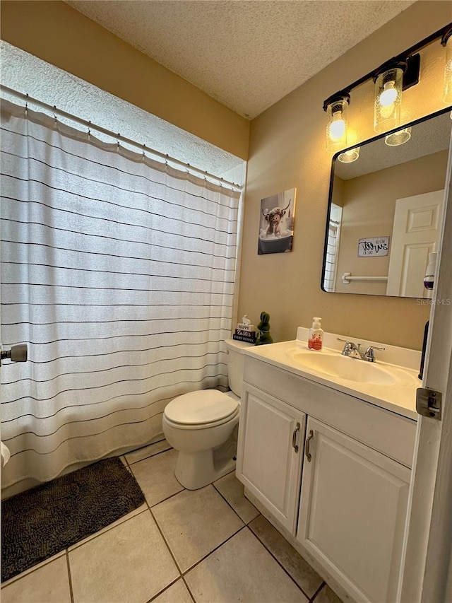 full bath with toilet, a shower with shower curtain, tile patterned floors, a textured ceiling, and vanity