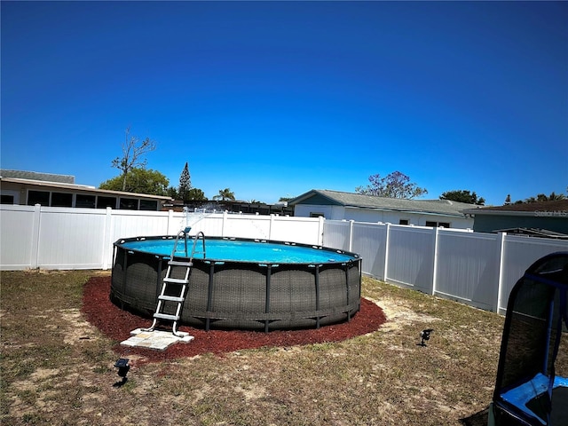 view of yard featuring a fenced backyard and a fenced in pool