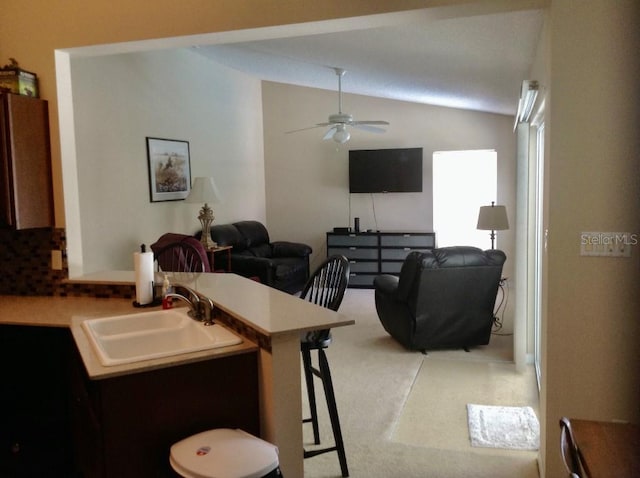 3850 Plantation Blvd, Leesburg, FL 34748 - kitchen with a kitchen breakfast bar, lofted ceiling, a sink, ceiling fan, and a peninsula