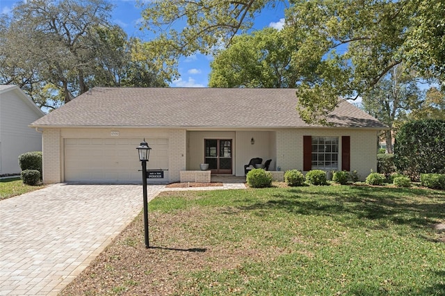 6530 Pine Meadows Dr, Spring Hill, FL 34606 - ranch-style house with a front lawn, decorative driveway, an attached garage, and brick siding