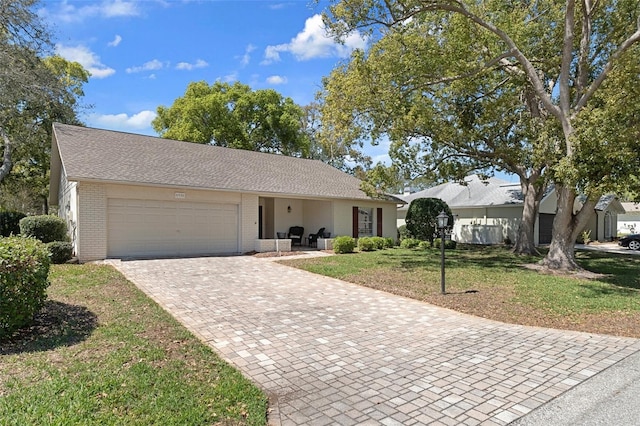 6530 Pine Meadows Dr, Spring Hill, FL 34606 - ranch-style house featuring a front yard, decorative driveway, a garage, and brick siding