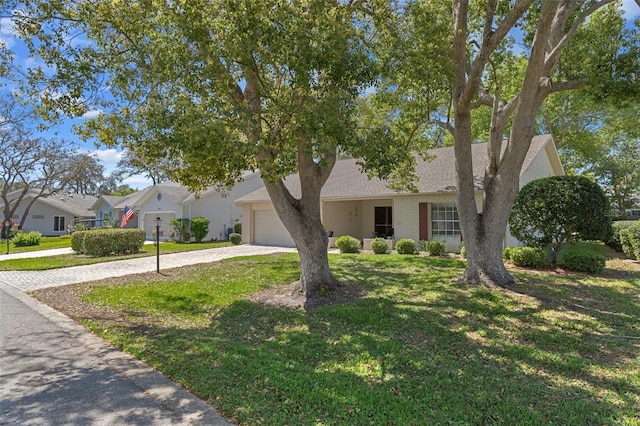 6530 Pine Meadows Dr, Spring Hill, FL 34606 - view of front of property featuring a residential view, a front yard, driveway, and an attached garage