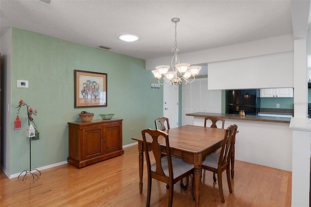 6530 Pine Meadows Dr, Spring Hill, FL 34606 - dining space featuring light wood finished floors, baseboards, visible vents, and an inviting chandelier