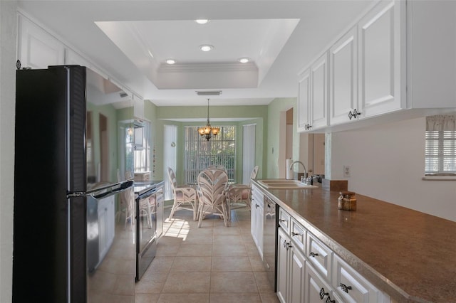 6530 Pine Meadows Dr, Spring Hill, FL 34606 - kitchen with white cabinetry, a raised ceiling, stainless steel appliances, and a notable chandelier