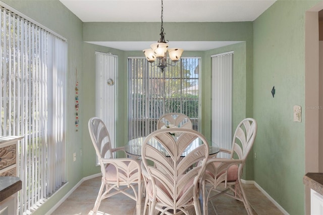 6530 Pine Meadows Dr, Spring Hill, FL 34606 - dining room featuring light tile patterned flooring, baseboards, and a notable chandelier