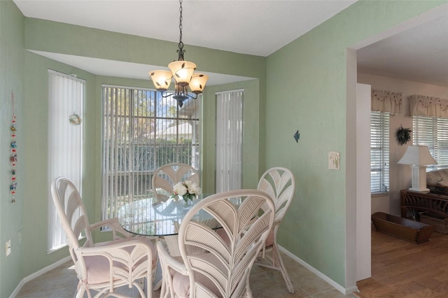 6530 Pine Meadows Dr, Spring Hill, FL 34606 - dining space featuring an inviting chandelier, a healthy amount of sunlight, and baseboards