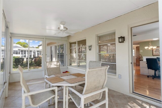 6530 Pine Meadows Dr, Spring Hill, FL 34606 - sunroom with ceiling fan with notable chandelier and outdoor dining space