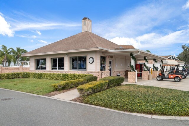 6530 Pine Meadows Dr, Spring Hill, FL 34606 - view of front of property with a chimney and a front yard