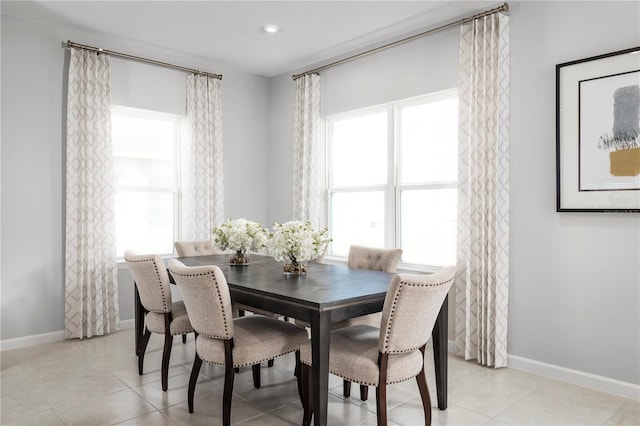 dining space with light tile patterned floors, baseboards, a healthy amount of sunlight, and recessed lighting