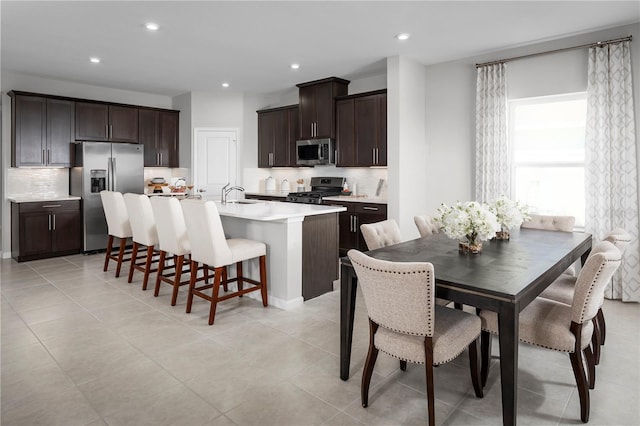 dining room with light tile patterned flooring and recessed lighting