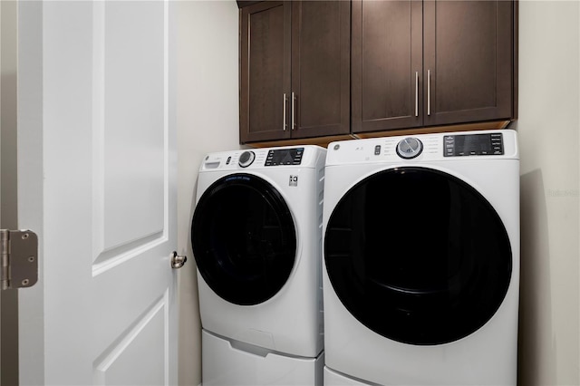 laundry area with cabinet space and washer and clothes dryer