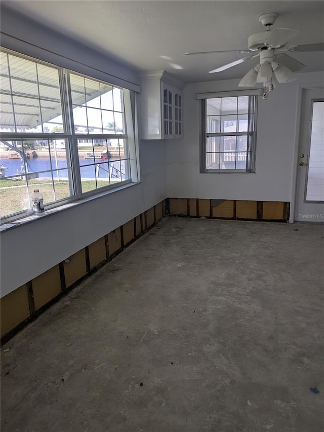 6536 Beach Blvd, Hudson, FL 34667 - unfurnished room featuring concrete floors, plenty of natural light, and a ceiling fan