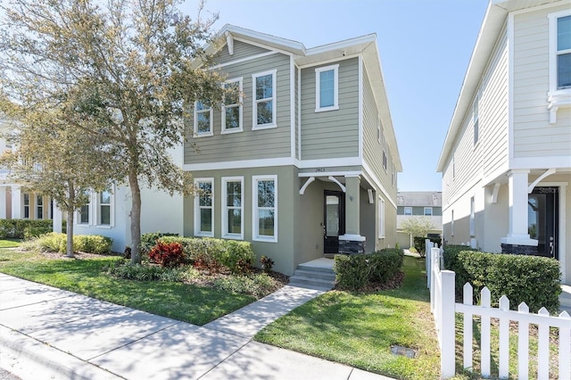 3465 Bumelia Ln, New Port Richey, FL 34655 - view of front facade with a front yard, fence, and stucco siding