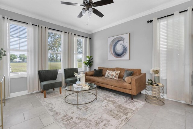 3465 Bumelia Ln, New Port Richey, FL 34655 - living room featuring light tile patterned floors, ornamental molding, baseboards, and a ceiling fan