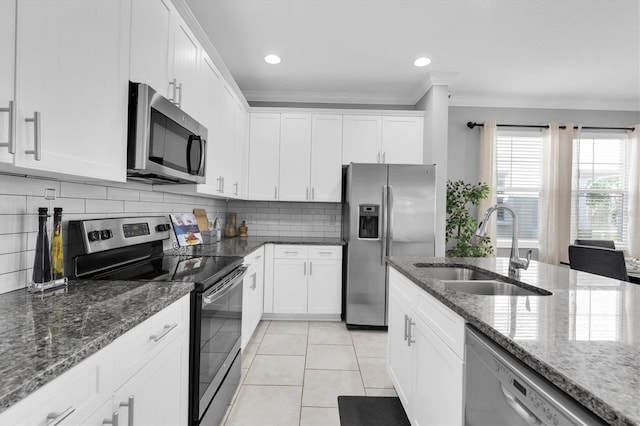 3465 Bumelia Ln, New Port Richey, FL 34655 - kitchen featuring decorative backsplash, ornamental molding, stainless steel appliances, a sink, and light tile patterned floors