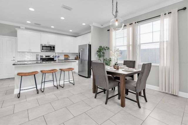 3465 Bumelia Ln, New Port Richey, FL 34655 - dining room with baseboards, ornamental molding, visible vents, and light tile patterned flooring