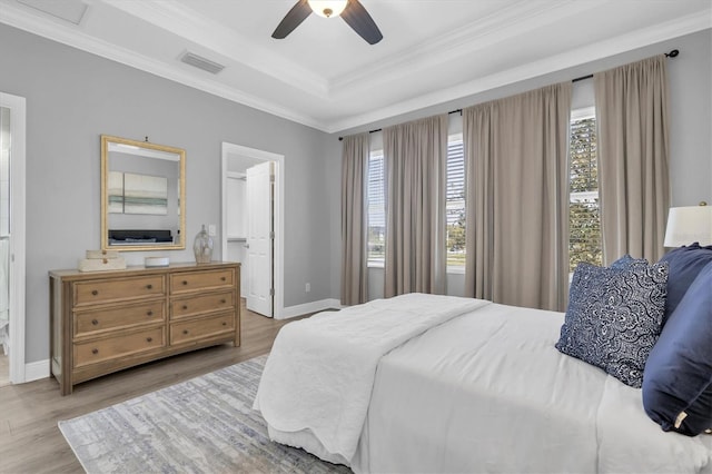 3465 Bumelia Ln, New Port Richey, FL 34655 - bedroom featuring visible vents, baseboards, ornamental molding, wood finished floors, and a tray ceiling