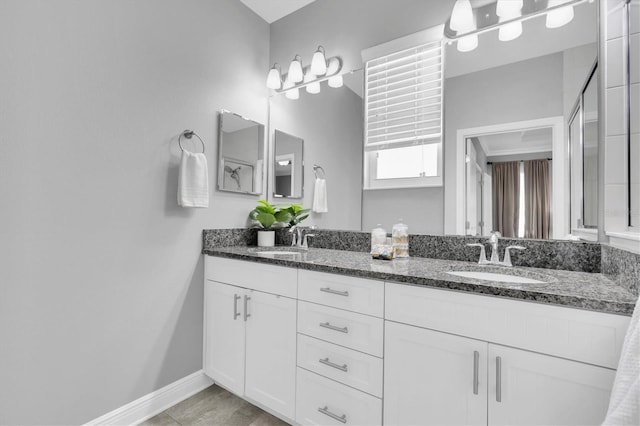 3465 Bumelia Ln, New Port Richey, FL 34655 - bathroom featuring baseboards, double vanity, and a sink