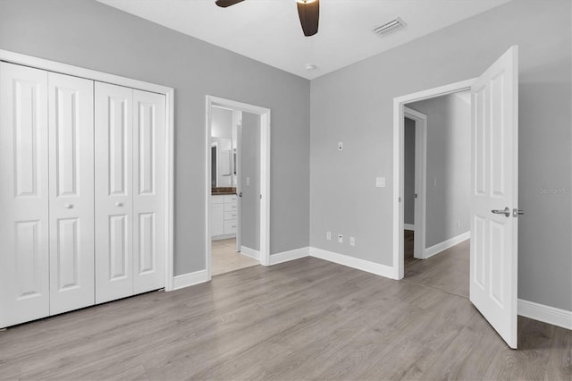 3465 Bumelia Ln, New Port Richey, FL 34655 - unfurnished bedroom featuring baseboards, connected bathroom, visible vents, a closet, and wood finished floors