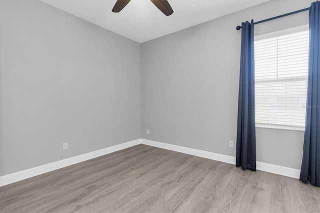 3465 Bumelia Ln, New Port Richey, FL 34655 - empty room with baseboards, wood finished floors, and a ceiling fan