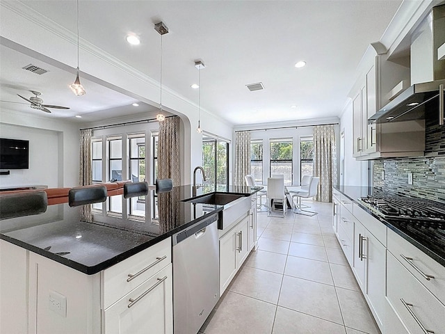 kitchen with dark countertops, visible vents, tasteful backsplash, and dishwasher