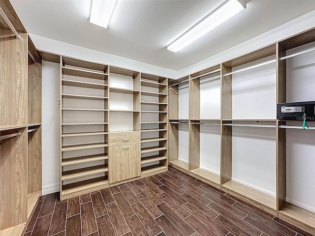 walk in closet featuring dark wood-type flooring