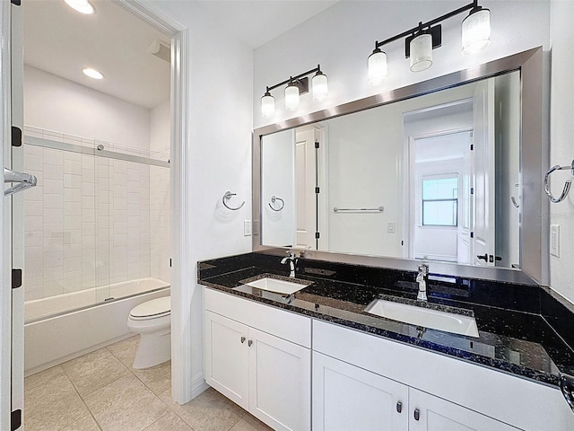 bathroom featuring a sink, tile patterned floors, toilet, and tub / shower combination