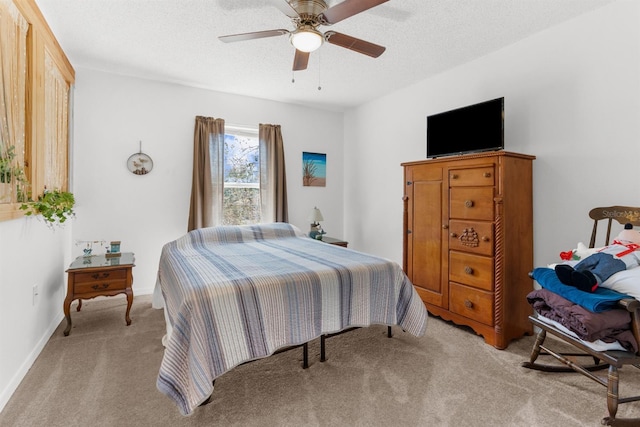 bedroom with baseboards, a textured ceiling, a ceiling fan, and light colored carpet