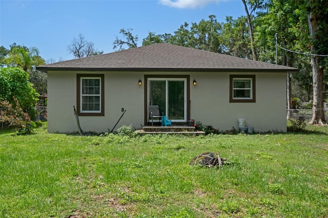 604 Kinnear Dr, Brooksville, FL 34601 - rear view of property featuring stucco siding and a yard