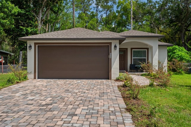 604 Kinnear Dr, Brooksville, FL 34601 - view of front of property featuring decorative driveway, stucco siding, a garage, and fence