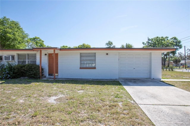 5800 Madison St, New Port Richey, FL 34652 - ranch-style house with driveway, a garage, a front lawn, and concrete block siding