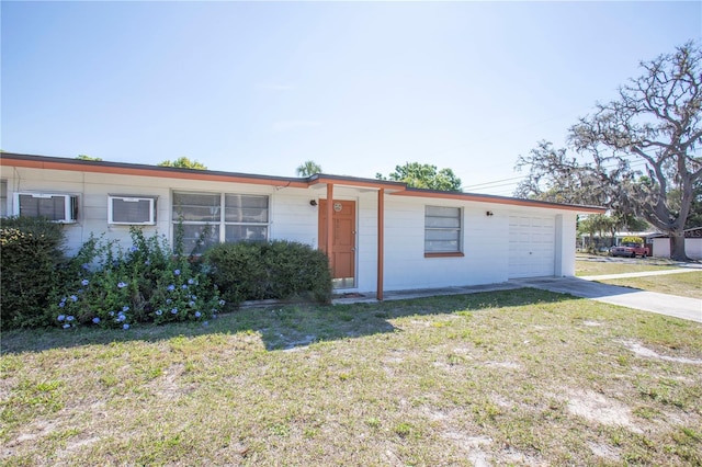 5800 Madison St, New Port Richey, FL 34652 - view of front facade featuring driveway, a garage, a front lawn, and concrete block siding
