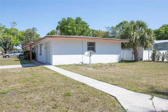 5800 Madison St, New Port Richey, FL 34652 - exterior space featuring concrete block siding, a front yard, and fence