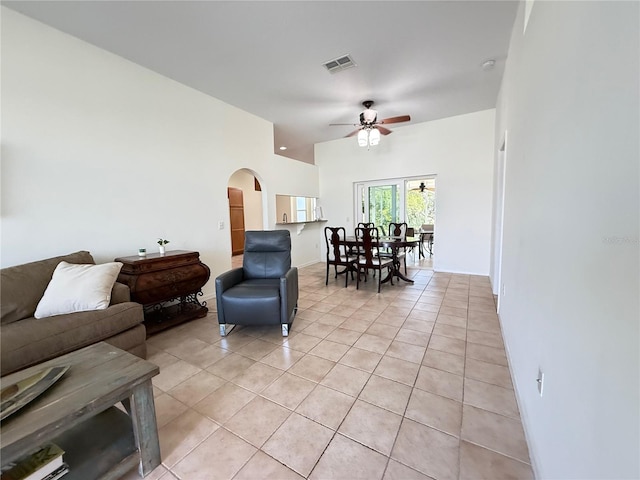9348 Villa Entrada, New Port Richey, FL 34655 - living room featuring arched walkways, light tile patterned floors, ceiling fan, and visible vents