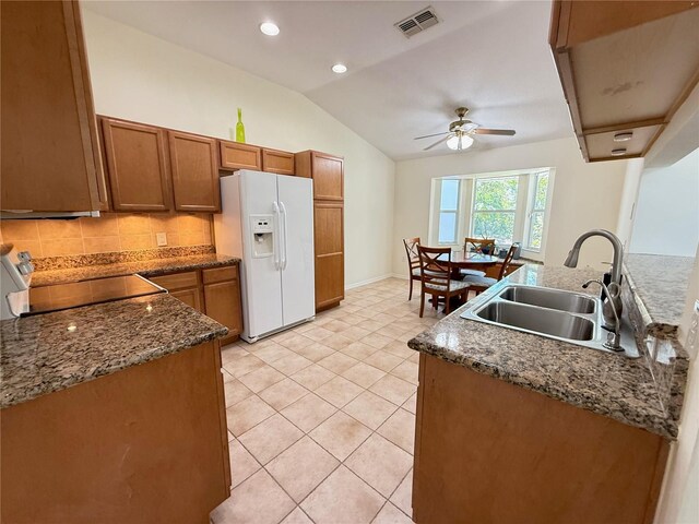 9348 Villa Entrada, New Port Richey, FL 34655 - kitchen with visible vents, a sink, ceiling fan, brown cabinetry, and white refrigerator with ice dispenser