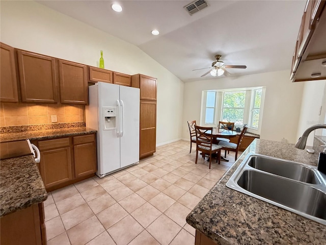 9348 Villa Entrada, New Port Richey, FL 34655 - kitchen featuring white fridge with ice dispenser, a ceiling fan, visible vents, a sink, and lofted ceiling