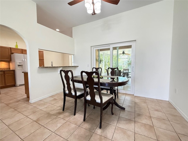 9348 Villa Entrada, New Port Richey, FL 34655 - dining space featuring light tile patterned floors, a towering ceiling, baseboards, and a ceiling fan