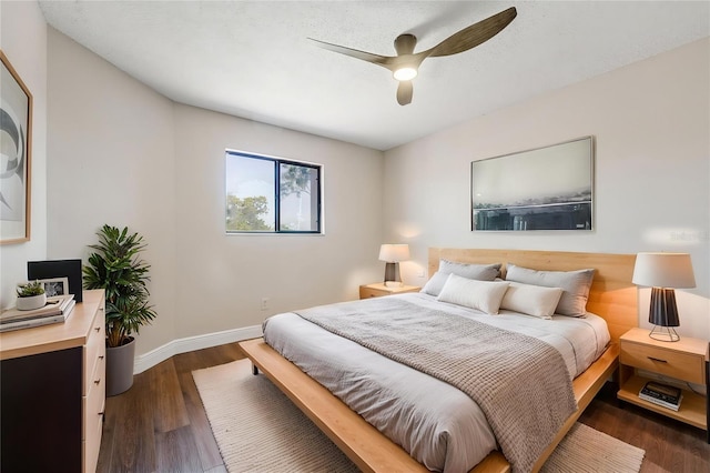 bedroom with dark wood-type flooring, baseboards, and ceiling fan