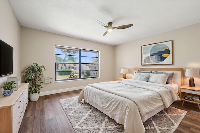 bedroom featuring baseboards, dark wood-style floors, and ceiling fan