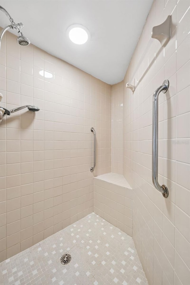 bathroom with tiled shower
