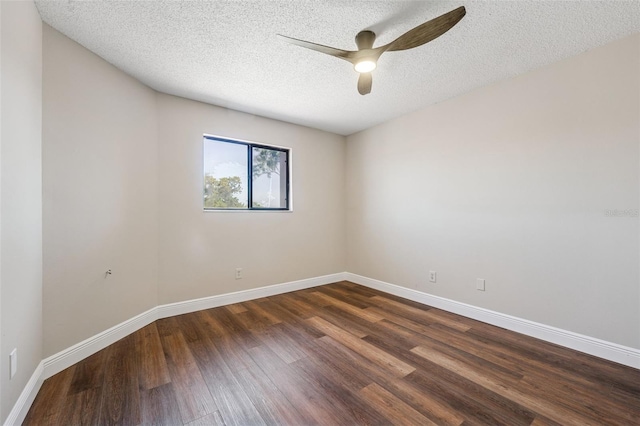 empty room featuring dark wood finished floors, a textured ceiling, baseboards, and ceiling fan