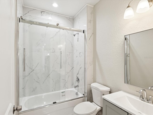 full bath featuring a textured wall, shower / bath combination with glass door, toilet, and vanity