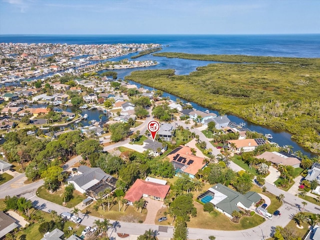 drone / aerial view with a water view and a residential view