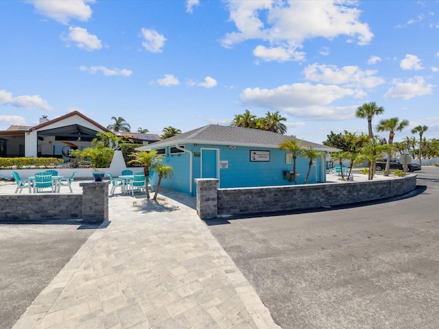 view of front of home featuring stone siding and a patio area