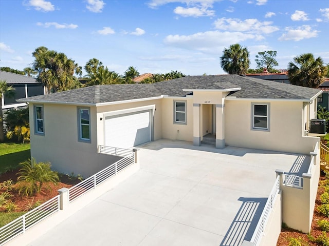 view of front of property featuring driveway, fence, a garage, stucco siding, and cooling unit