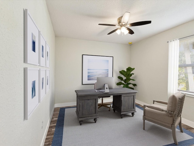 office space with wood finished floors, baseboards, and ceiling fan