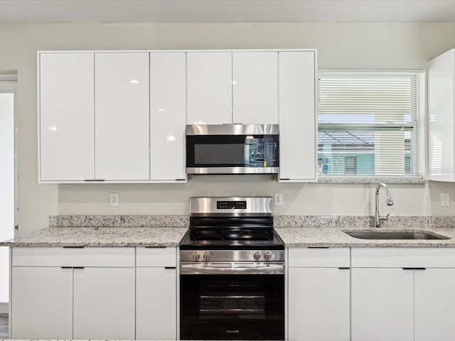 kitchen featuring white cabinets, a sink, and stainless steel appliances
