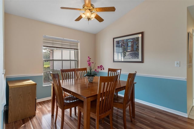 dining room with wood finished floors, baseboards, ceiling fan, and vaulted ceiling